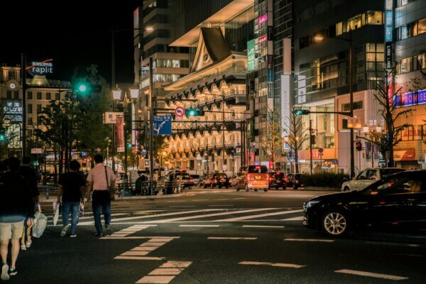 People walking on Japan street at night time with employment visa Japan